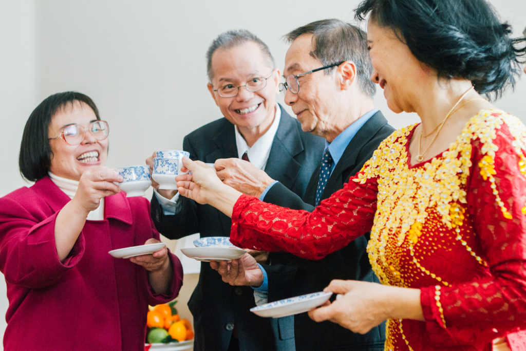 Parents of both sides happily cheers during a traditional Vietnamese tea ceremony
